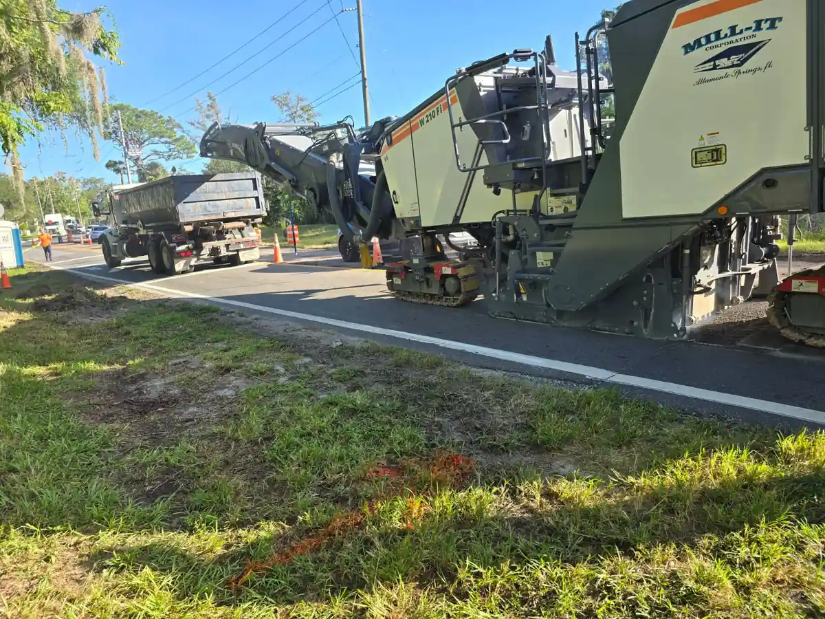Close view of the Wirtgen W 210 Fi milling machine and conveyor on a Daytona Beach, Florida road