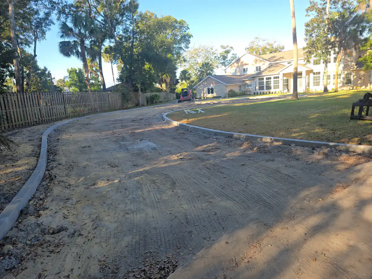 Residential street in Sanford, Florida, stripped to bare base with the concrete valley gutter left in place on both sides
