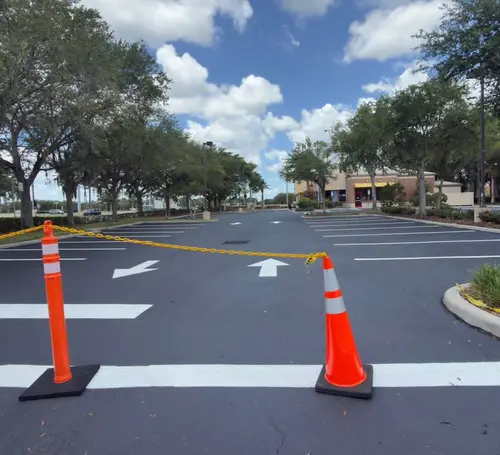 Newly striped crosswalk and traffic cones on a commercial lot in DeLand, Florida