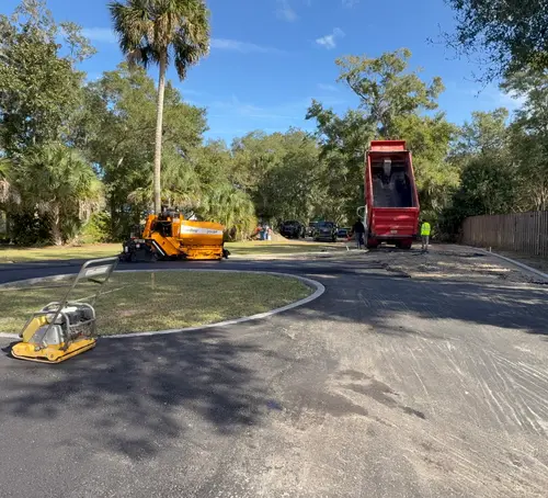 Freshly paved residential cul-de-sac in DeLand, Florida with the paving crew still on site
