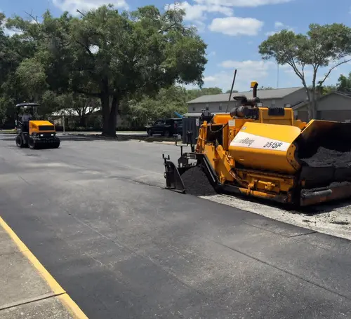 Paver laying a fresh asphalt surface on a residential property in DeLand, Florida