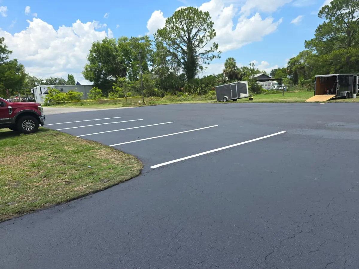 New white stall lines on the freshly sealed back lot at Los Dos Compadres in DeLand, Florida