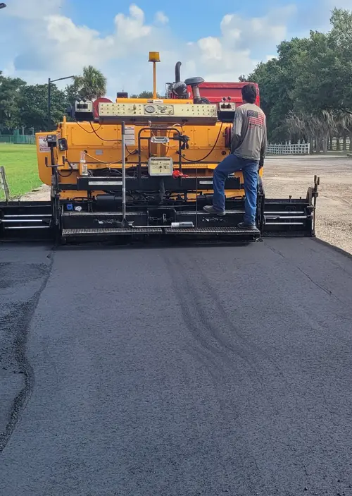 M&S Asphalt Paving crew running a paver over fresh asphalt in DeLand, Florida