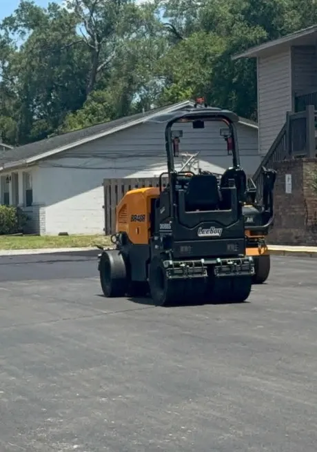 Roller compacting a newly paved residential surface in Volusia County, Florida