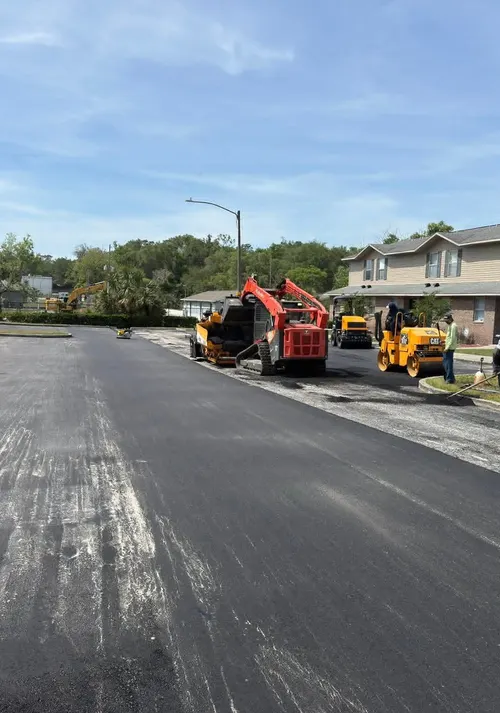 Freshly laid asphalt road in a DeLand neighbourhood with the paving crew and roller still on site